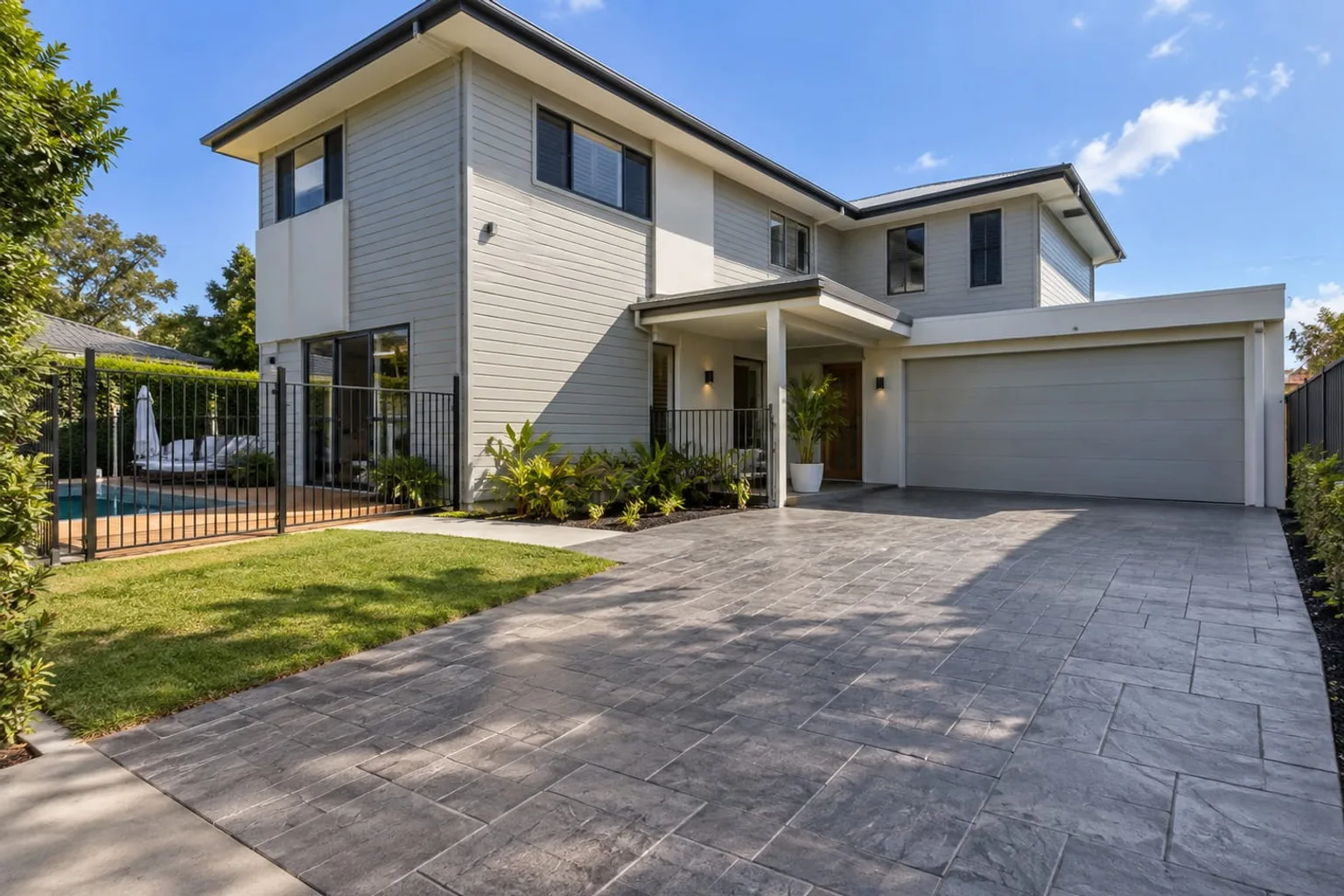 Charcoal stamped concrete driveway in a slate tile pattern at a modern Mackay home